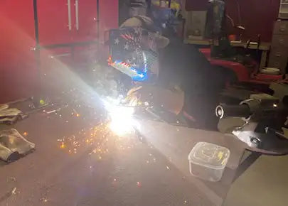 Blue and white welding helmet with clear visor