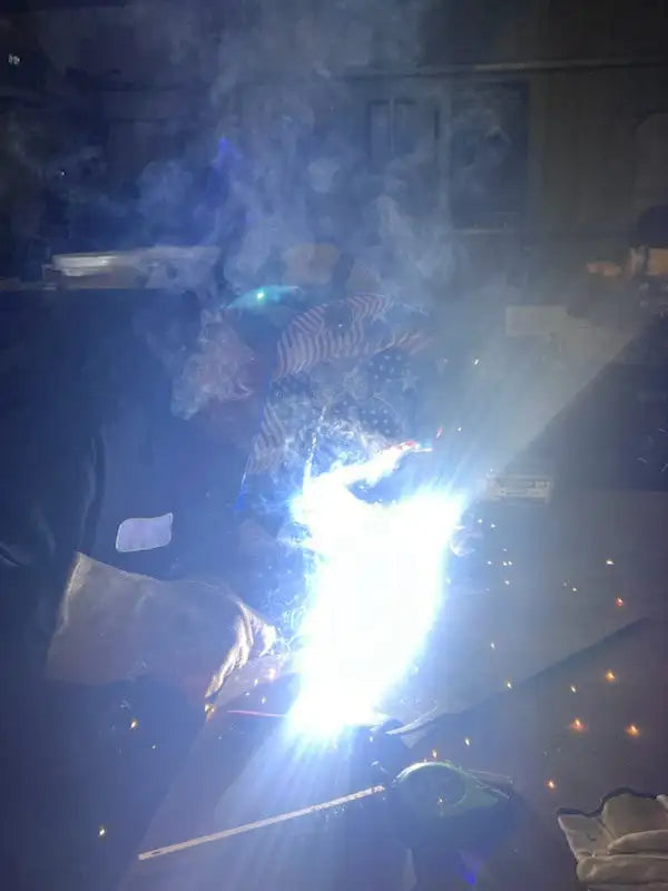 Welding helmet with bright light and protective visor.