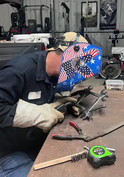 Patriotic-themed welding helmet with american flag design and stars, made of durable metal.