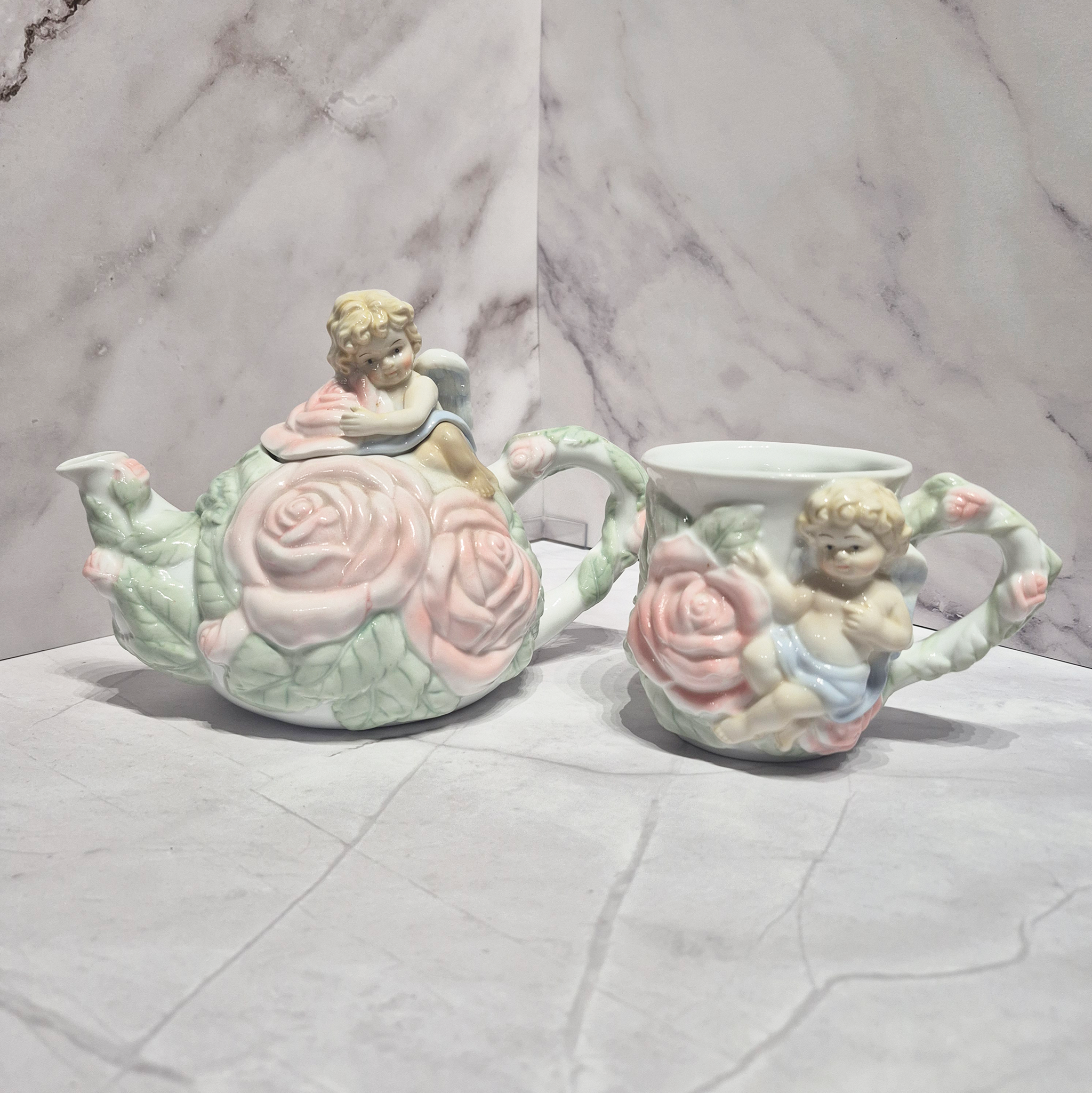 🌸 Vintage Avon Cherub Rose Teapot & Mug Set 🌸 featuring rose detailing and cherub sculptures.